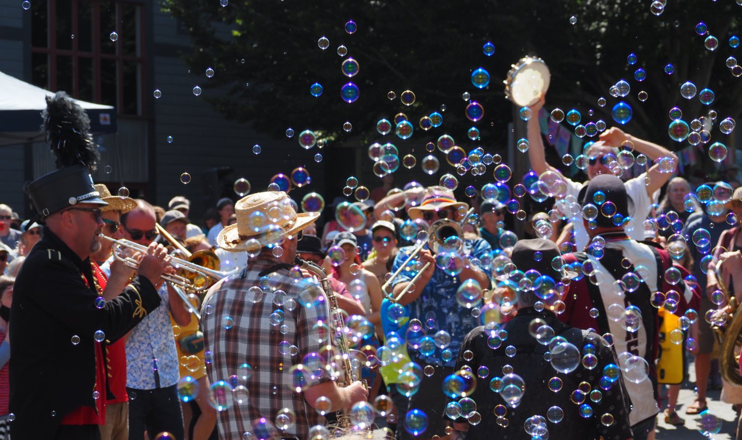 The Unexpected Brass Band circled up in a sea of bubbles at the end of the parade for a dance party with the crowd.
